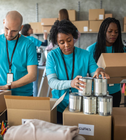 Volunteers stacking boxes things to donate